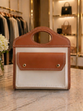 The First Lady Tote in caramel and ivory with cutout top handle and gold-tone accents